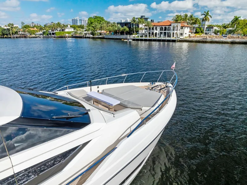 Slide: The Image of 2019 Ferretti Yachts 780 on serene water with luxury waterfront homes in background. - 7