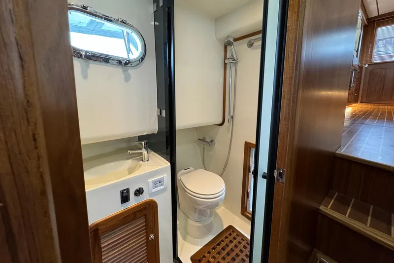 Slide: The Image of Bathroom interior of 2026 Helmsman Trawlers 38 Sedan with shower and wooden accents. - 15