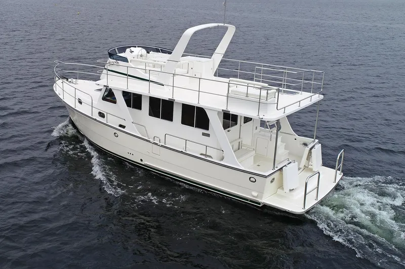 Slide: The Image of 2026 Helmsman Trawlers 38 Sedan cruising on open water, showcasing sleek design and spacious deck. - 5