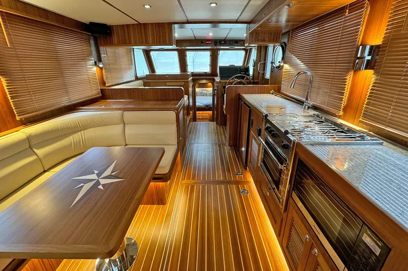 Slide: The Image of Luxurious interior of 2026 Helmsman Trawlers 38 Sedan with wood finishes and modern amenities. - 8