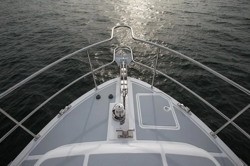 Slide: The Image of Bow view of 2026 Helmsman Trawlers 38E Pilothouse on open water. - 14