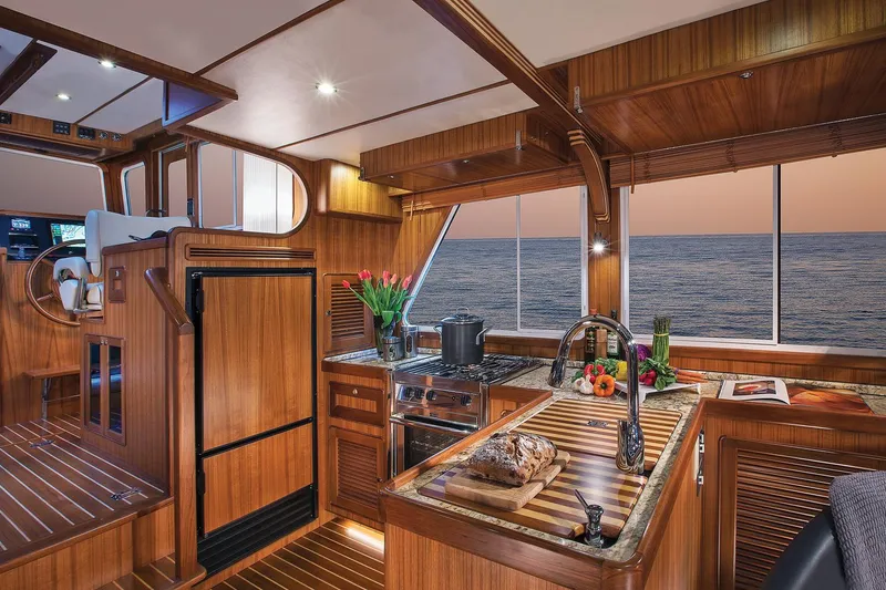 Slide: The Image of Luxurious 2026 Helmsman Trawlers 38E Pilothouse interior with elegant wood finish and ocean view. - 20