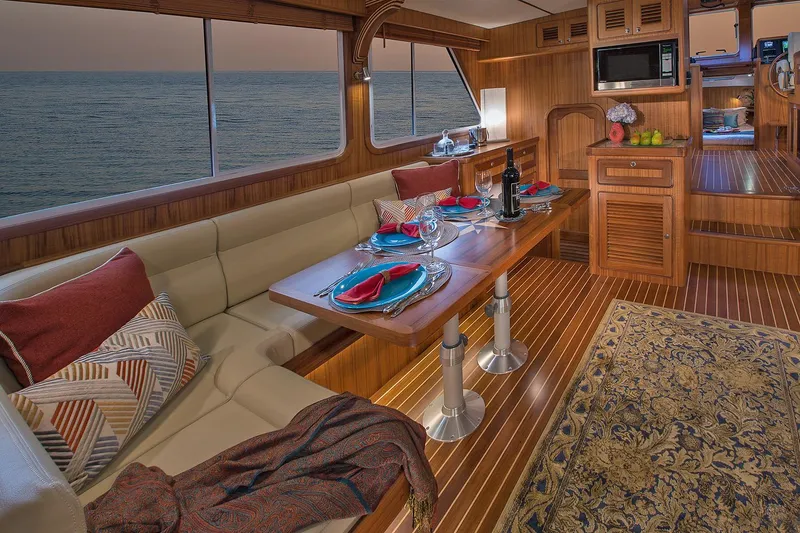 Slide: The Image of Luxurious interior of 2026 Helmsman Trawlers 38E Pilothouse with elegant dining setup. - 22