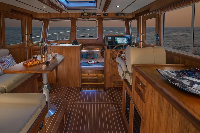 Slide: The Image of Luxurious 2026 Helmsman Trawlers 38E Pilothouse interior with elegant wood finish and ocean view. - 25