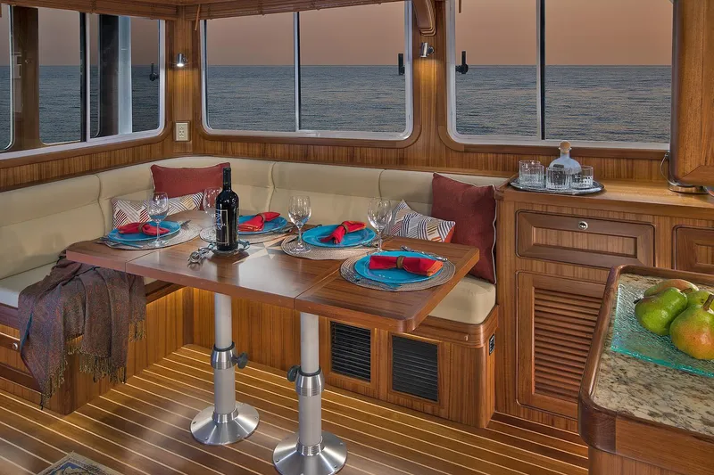 Slide: The Image of Luxurious interior of 2026 Helmsman Trawlers 38E Pilothouse with elegant dining setup. - 26