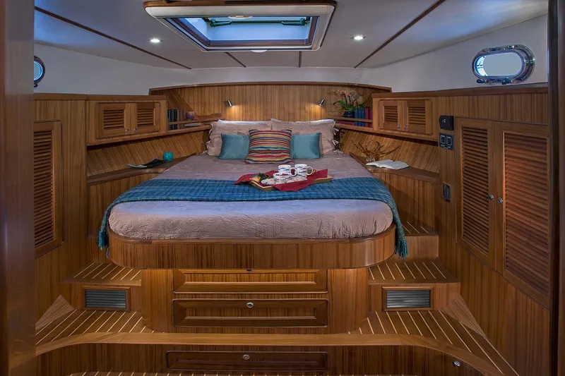 Slide: The Image of Luxurious cabin interior of 2026 Helmsman Trawlers 38E Pilothouse with cozy bed and wood finish. - 30