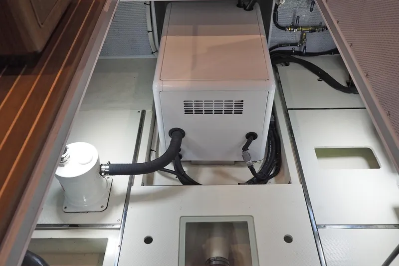 Slide: The Image of Engine room of 2026 Helmsman Trawlers 38E Pilothouse with visible machinery and wiring. - 37