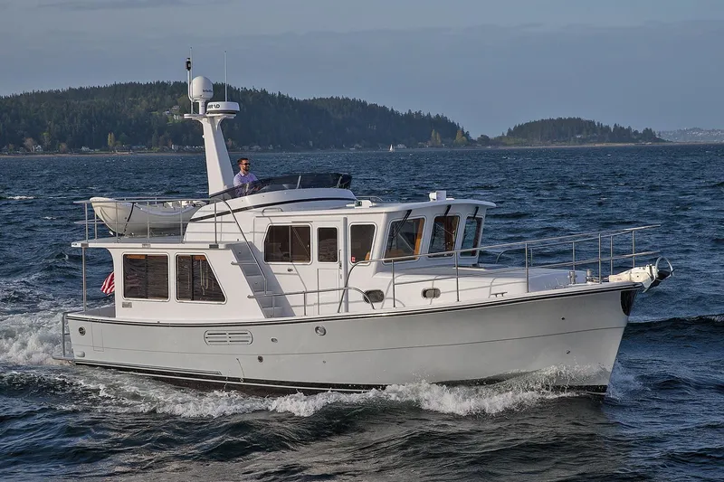 Slide: The Image of 2026 Helmsman Trawlers 38E Pilothouse cruising on open water. - 4