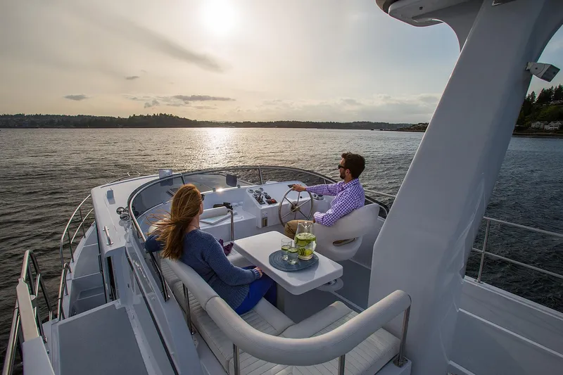 Slide: The Image of Couple enjoying sunset on 2026 Helmsman Trawlers 38E Pilothouse yacht. - 9