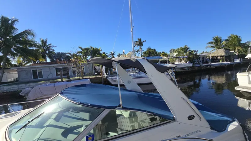 Slide: The Image of 2002 Sea Ray 340 Sundancer docked by palm trees under clear blue sky. - 1