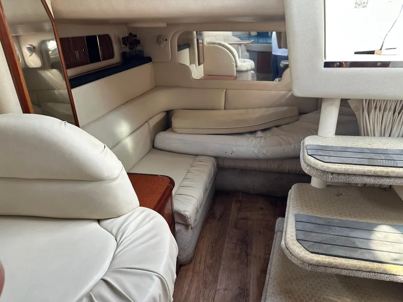 Slide: The Image of Interior of 2002 Sea Ray 340 Sundancer yacht with white seating and wooden flooring. - 20