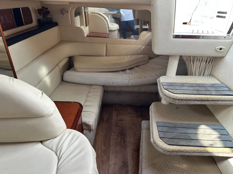 Slide: The Image of Interior of 2002 Sea Ray 340 Sundancer yacht with beige seating and wooden flooring. - 22