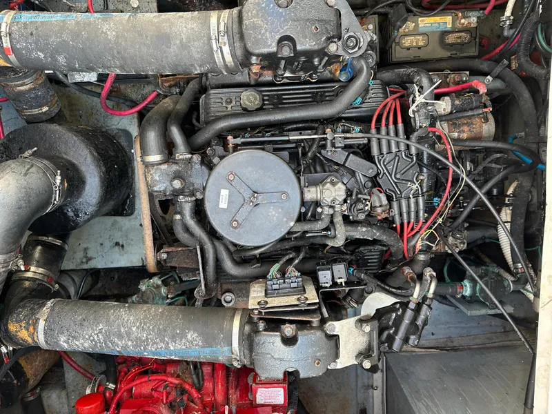 Slide: The Image of Engine compartment of a 2002 Sea Ray 340 Sundancer boat, showing detailed mechanical components. - 24
