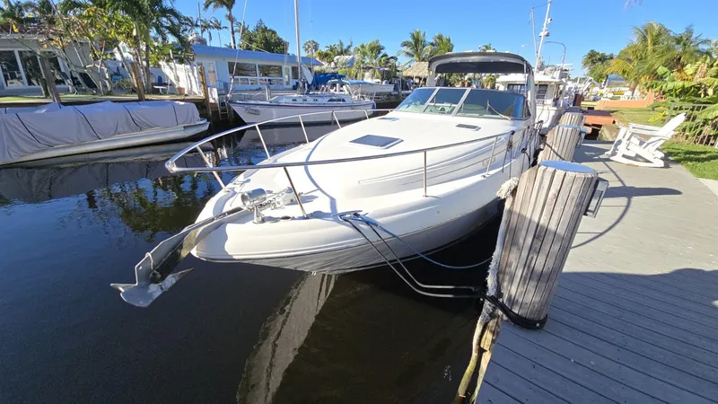 Slide: The Image of 2002 Sea Ray 340 Sundancer docked in a sunny marina setting. - 26
