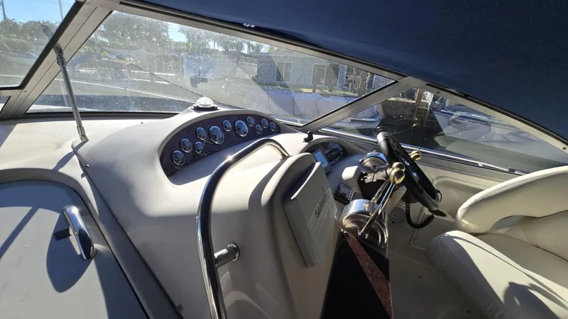 Slide: The Image of 2002 Sea Ray 340 Sundancer helm with gauges and steering wheel. - 3