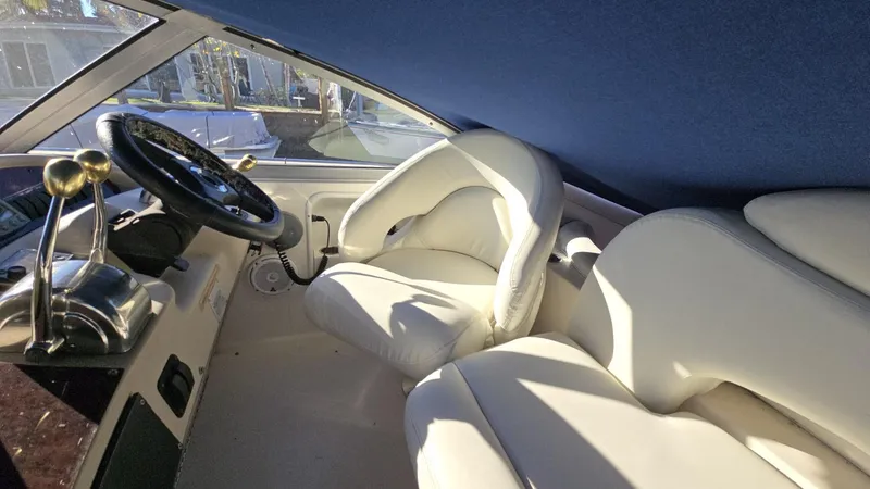 Slide: The Image of Interior of 2002 Sea Ray 340 Sundancer with white seating and steering wheel. - 4