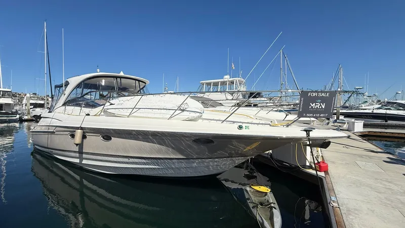 The Image of 2003 Regal Commodore 4260 yacht docked at marina, clear blue sky, for sale sign visible. - 1