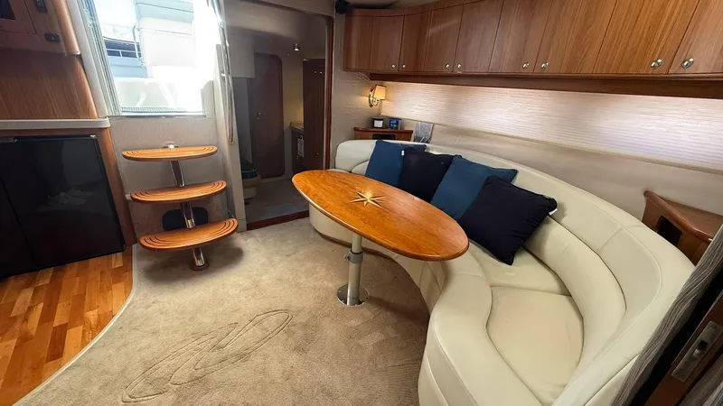 Slide: The Image of Luxurious interior of 2003 Regal Commodore 4260 yacht with plush seating and elegant wood finishes. - 12