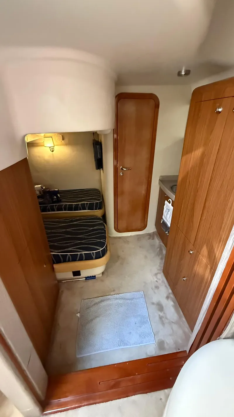 Slide: The Image of 2003 Regal Commodore 4260 cabin interior with twin beds and wooden cabinetry. - 16