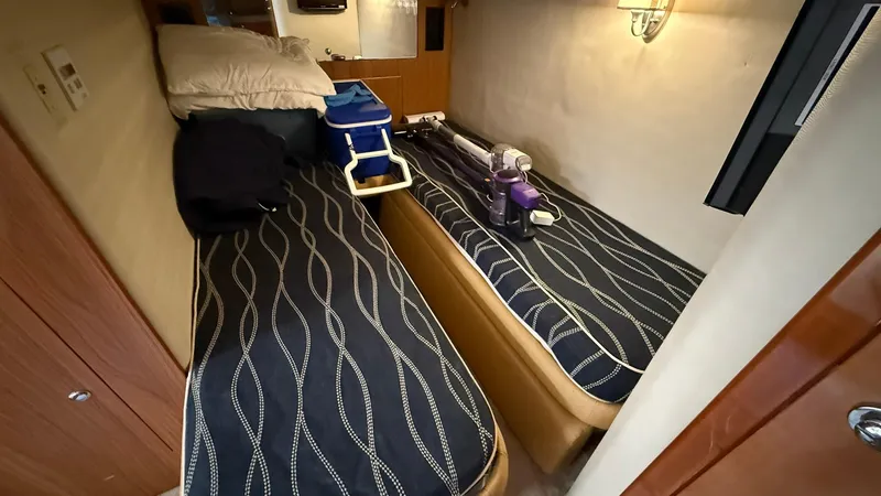 Slide: The Image of 2003 Regal Commodore 4260 cabin with twin beds and nautical decor. - 18