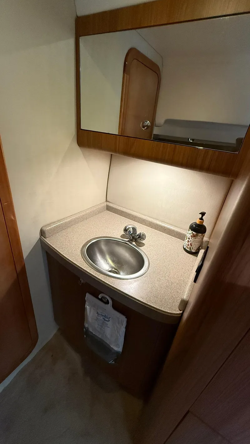 Slide: The Image of 2003 Regal Commodore 4260 bathroom with sink, mirror, and soap dispenser. - 20