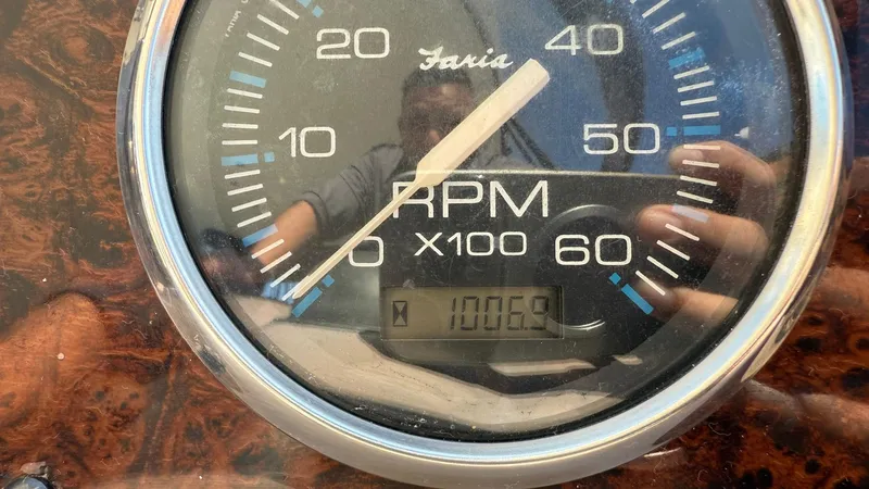 Slide: The Image of Close-up of a 2003 Regal Commodore 4260 RPM gauge showing 1005.8 hours. - 22