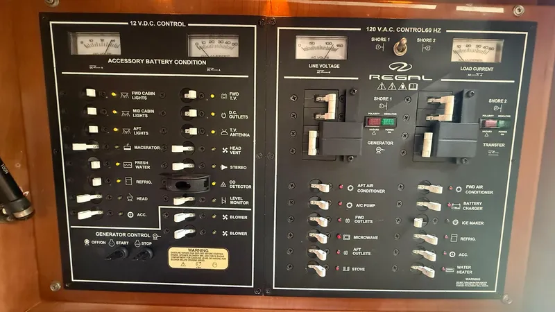 Slide: The Image of Control panel of a 2003 Regal Commodore 4260 boat, showing battery and power switches. - 23