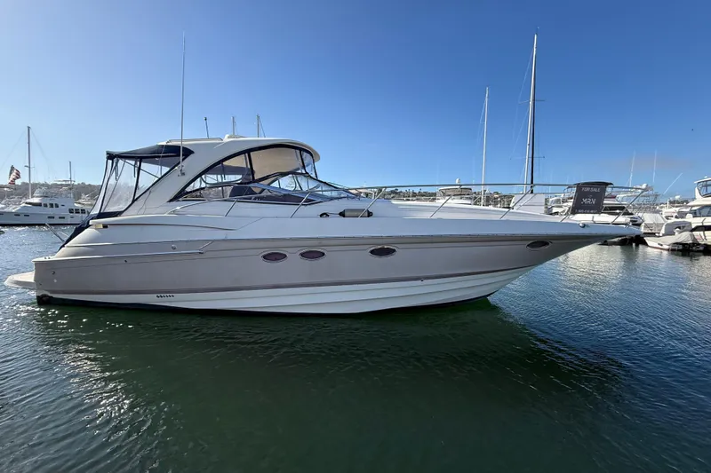 Slide: The Image of 2003 Regal Commodore 4260 yacht docked in marina, clear blue sky background. - 32