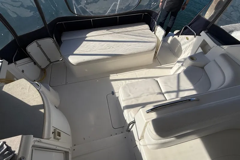 Slide: The Image of 2003 Regal Commodore 4260 yacht interior with white seating and sunlit deck area. - 33