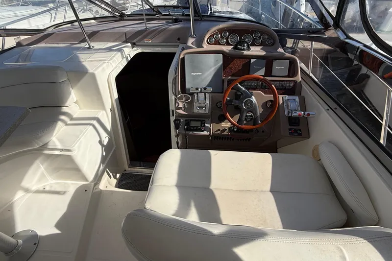 Slide: The Image of 2003 Regal Commodore 4260 yacht cockpit with steering wheel and navigation controls. - 35