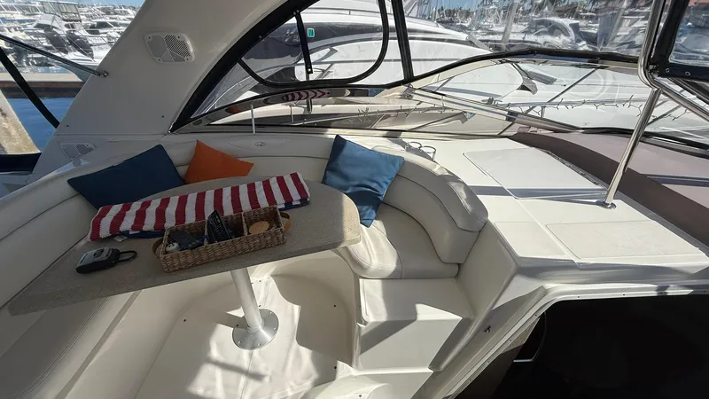 Slide: The Image of 2003 Regal Commodore 4260 yacht interior with seating, table, and colorful cushions. - 4