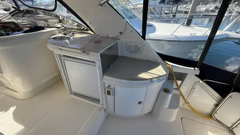 Slide: The Image of 2003 Regal Commodore 4260 yacht interior with kitchenette and seating area. - 6