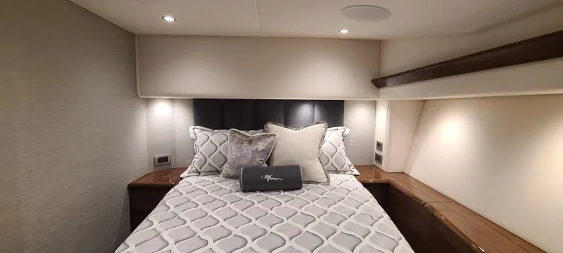 Slide: The Image of Luxurious bedroom interior of 2024 Viking 54 Convertible yacht with elegant bedding. - 4