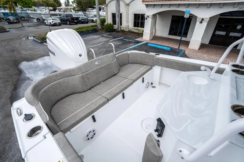 Slide: The Image of 2025 Sea Hunt Ultra 245 SE boat interior with gray seating and Yamaha engine. - 11