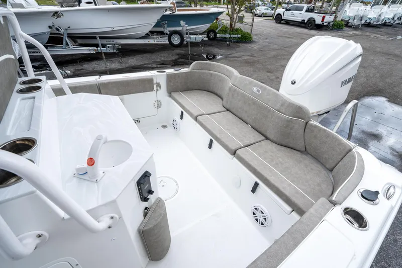 Slide: The Image of 2025 Sea Hunt Ultra 245 SE boat interior with seating and Yamaha engine. - 12