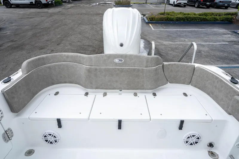 Slide: The Image of 2025 Sea Hunt Ultra 245 SE boat interior with cushioned seating and storage compartments. - 13