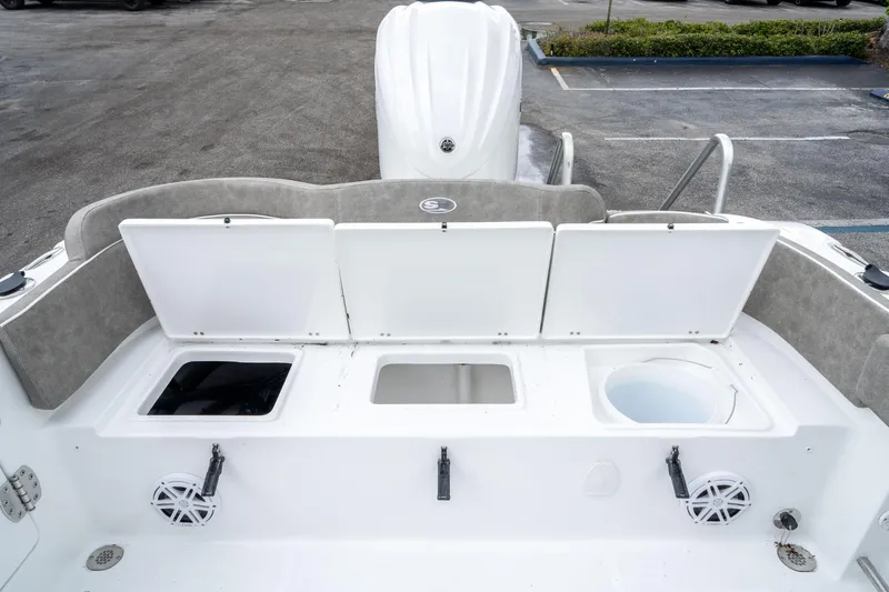 Slide: The Image of 2025 Sea Hunt Ultra 245 SE boat with open storage compartments and speakers. - 14