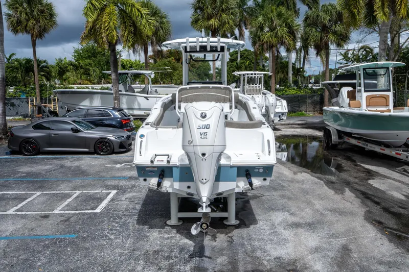 Slide: The Image of 2025 Sea Hunt Ultra 245 SE boat in a parking lot with palm trees. - 3
