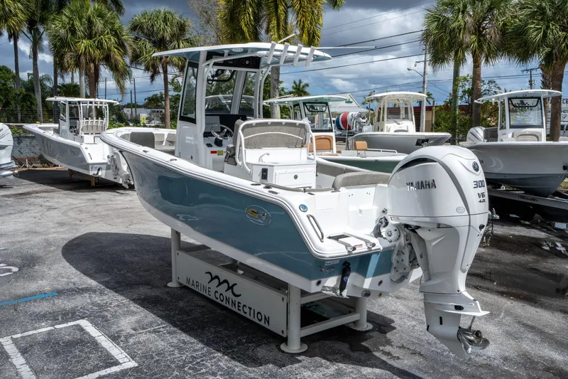 Slide: The Image of 2025 Sea Hunt Ultra 245 SE boat with Yamaha engine, displayed outdoors. - 4