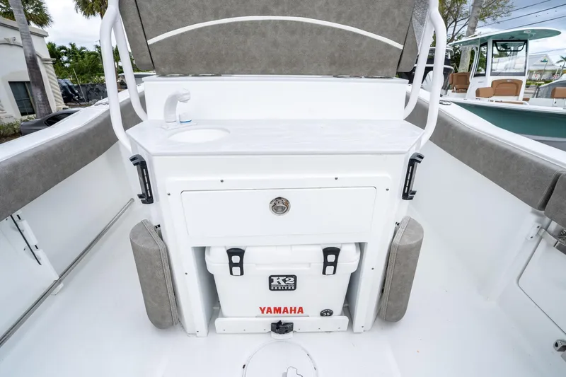 Slide: The Image of 2025 Sea Hunt Ultra 245 SE boat interior with sink and storage area. - 15
