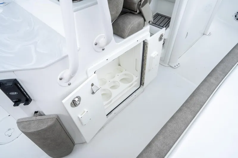 Slide: The Image of 2025 Sea Hunt Ultra 245 SE boat interior with open storage compartment. - 17