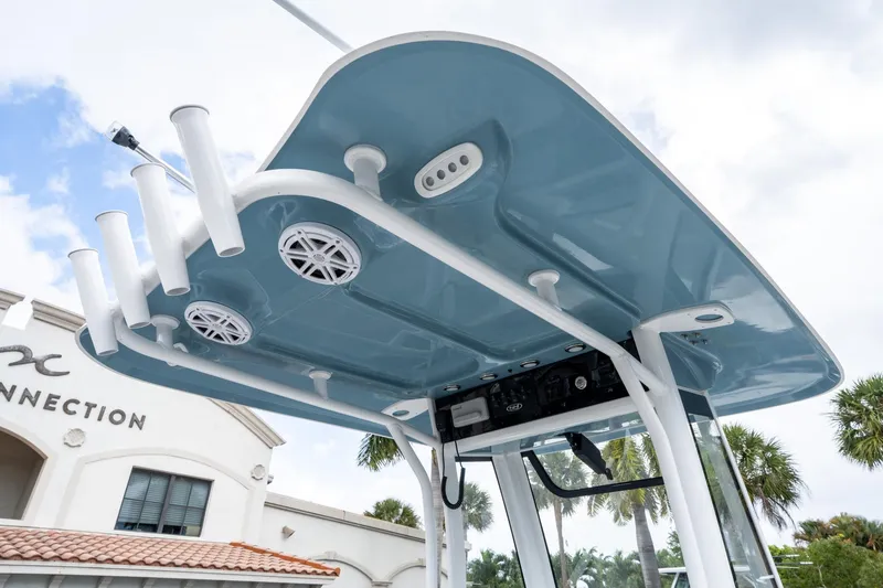 Slide: The Image of 2025 Sea Hunt Ultra 245 SE boat's T-top with rod holders and speakers. - 20