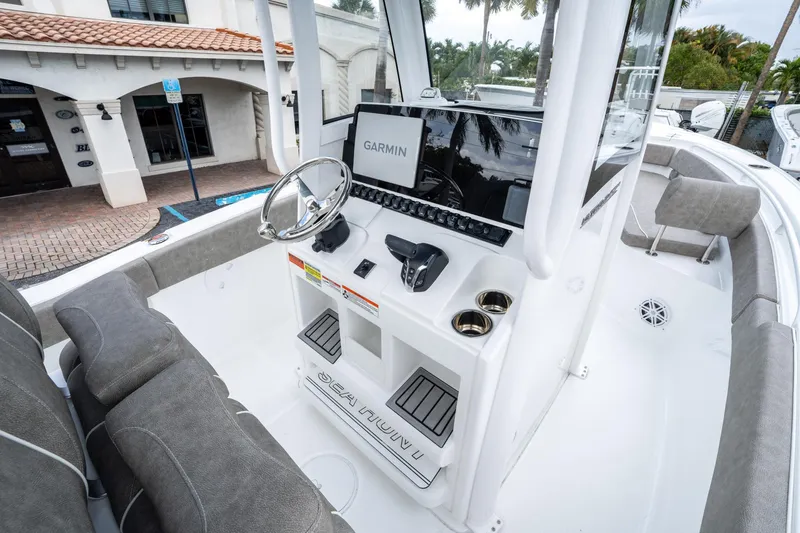 Slide: The Image of 2025 Sea Hunt Ultra 245 SE boat interior with Garmin navigation system and comfortable seating. - 23