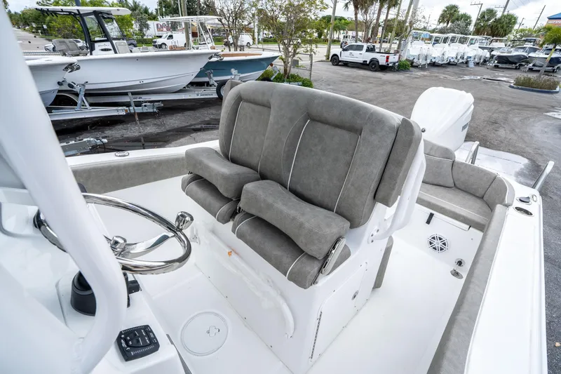 Slide: The Image of 2025 Sea Hunt Ultra 245 SE boat interior with plush seating and steering wheel. - 25