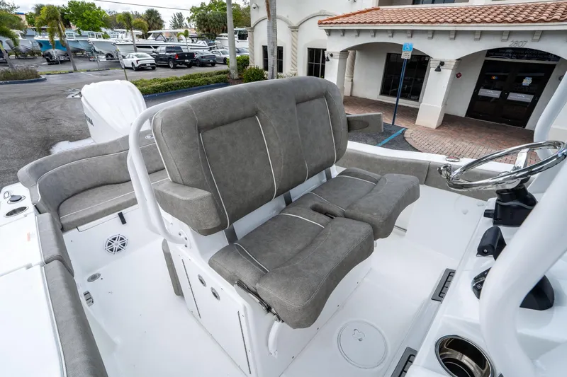 Slide: The Image of 2025 Sea Hunt Ultra 245 SE boat interior with gray seating and steering wheel. - 27