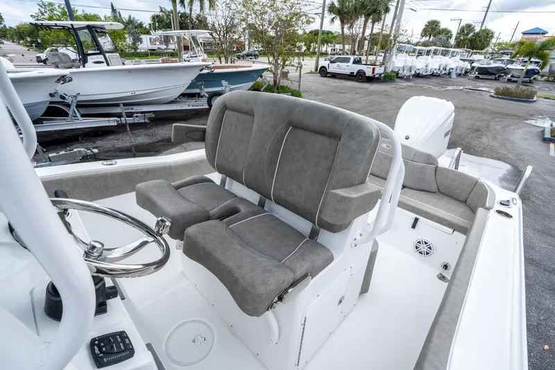 Slide: The Image of 2025 Sea Hunt Ultra 245 SE boat interior with gray seating and steering wheel. - 28
