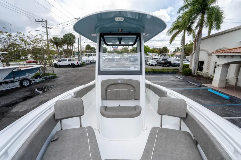 Slide: The Image of 2025 Sea Hunt Ultra 245 SE boat interior with seating, parked in a marina. - 33