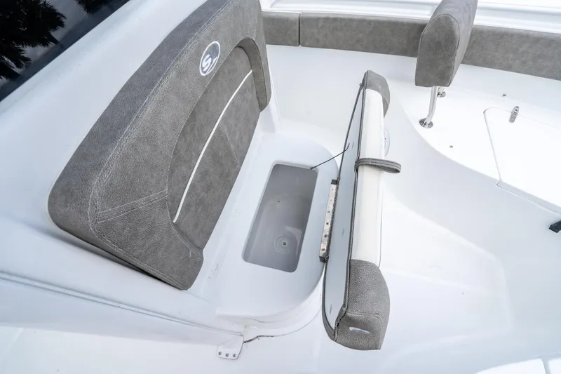 Slide: The Image of 2025 Sea Hunt Ultra 245 SE boat seat with storage compartment open. - 36