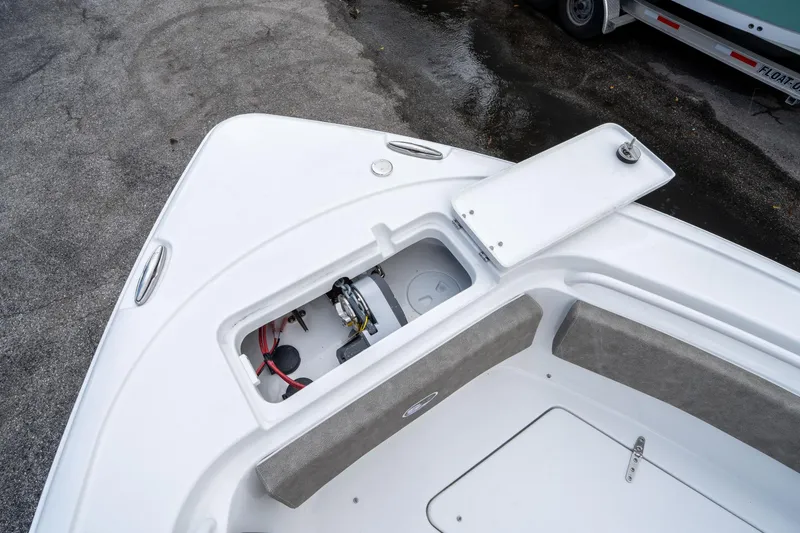 Slide: The Image of 2025 Sea Hunt Ultra 245 SE boat storage compartment with open hatch. - 37