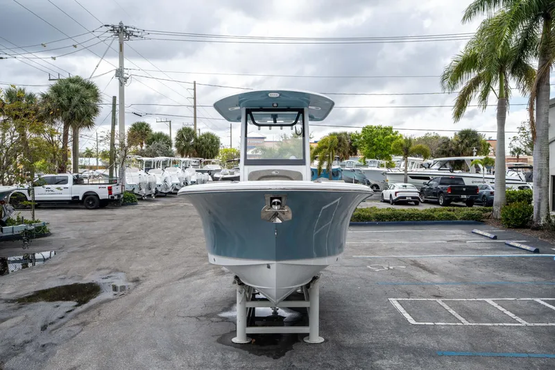 Slide: The Image of 2025 Sea Hunt Ultra 245 SE boat in a parking lot, surrounded by palm trees. - 7